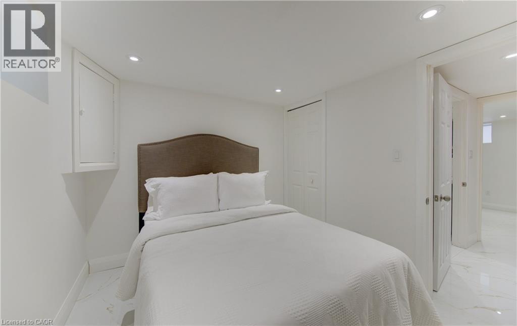 Bedroom featuring light marble finish floors, a closet, and recessed lighting - 569 Stirling Avenue S, Kitchener, ON - Indoor Photo Showing Bedroom