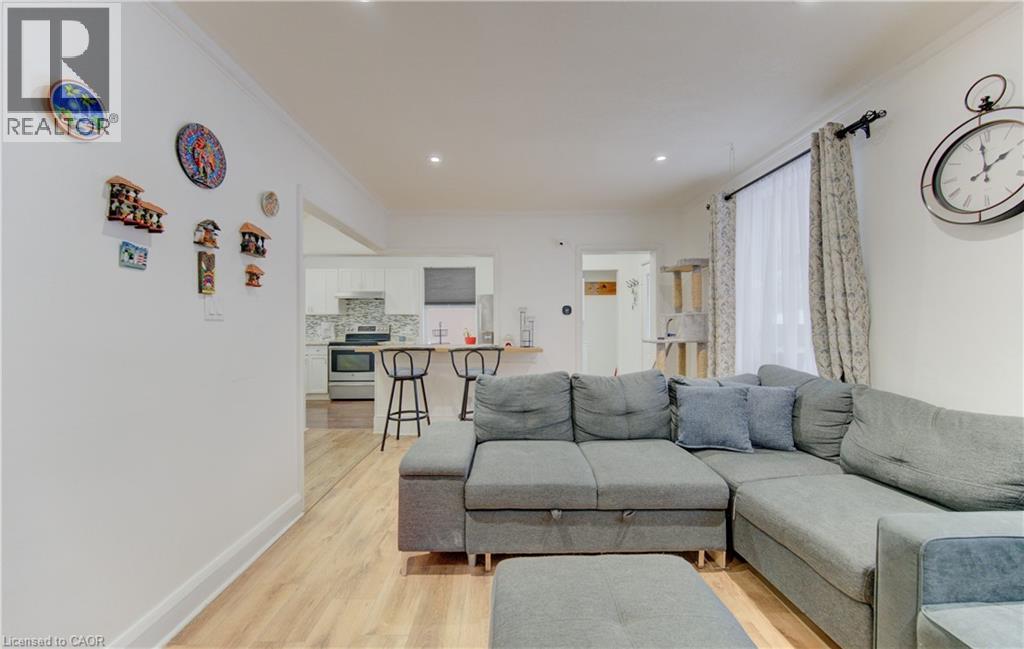 Living area with light wood-style floors and ornamental molding - 569 Stirling Avenue S, Kitchener, ON - Indoor Photo Showing Living Room