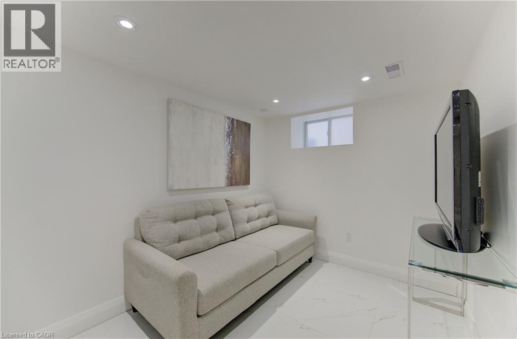 Living room with marble finish floors and recessed lighting - 569 Stirling Avenue S, Kitchener, ON - Indoor
