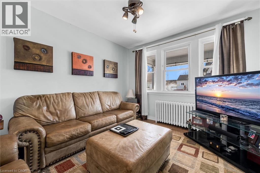 Living area with radiator heating unit and wood finished floors - 35 Bayfield Avenue, Hamilton, ON - Indoor Photo Showing Living Room