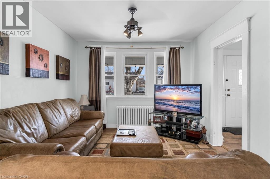 Living room with radiator heating unit and ceiling fan - 35 Bayfield Avenue, Hamilton, ON - Indoor Photo Showing Living Room
