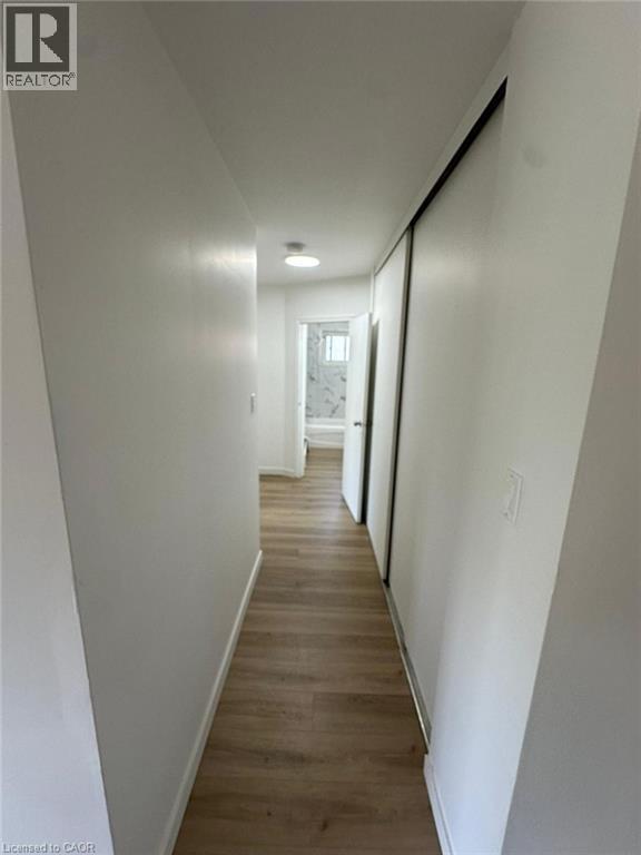 Hall with dark wood finished floors and baseboards - 145 Macgregor Crescent Unit# 1, Waterloo, ON - Indoor Photo Showing Other Room