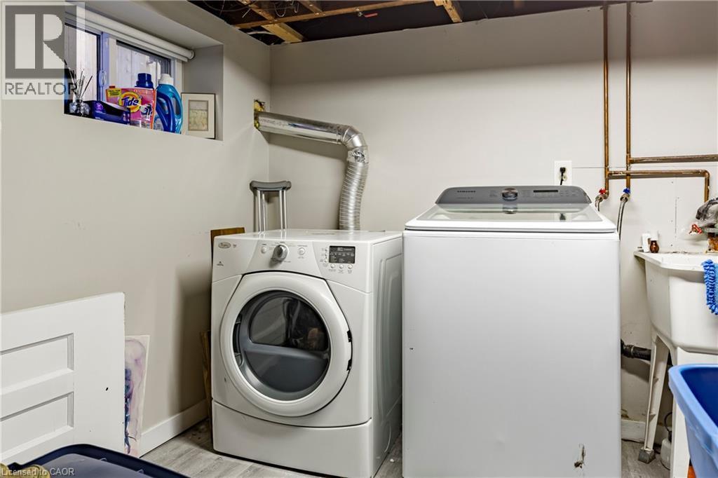 Laundry room featuring washer and dryer and baseboards - 58 Chatham Street, Hamilton, ON - Indoor Photo Showing Laundry Room