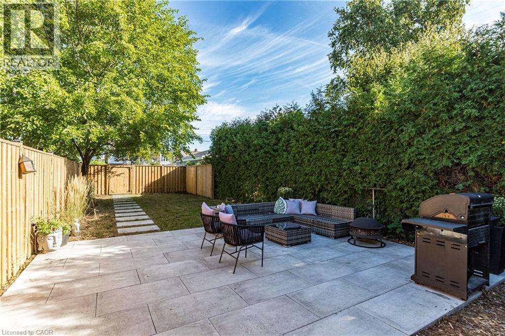 Fenced backyard with outdoor lounge area, a patio, and area for grilling - 58 Chatham Street, Hamilton, ON - Outdoor With Deck Patio Veranda