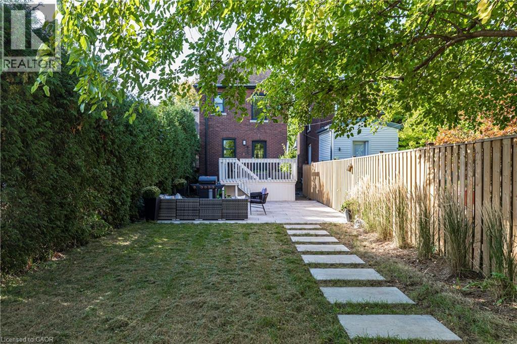 Fenced yard featuring a patio area and an outdoor hangout area - 58 Chatham Street, Hamilton, ON - Outdoor With Deck Patio Veranda