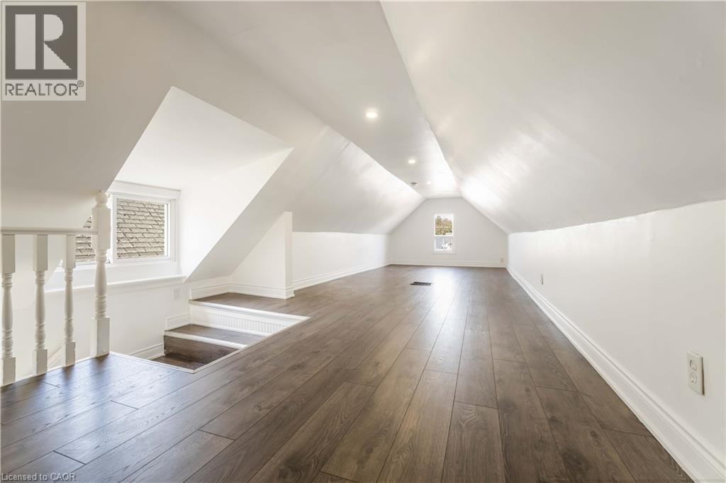 Additional living space featuring dark wood-style floors and vaulted ceiling - 934 Barton Street E Unit# 2, Hamilton, ON - Indoor Photo Showing Other Room