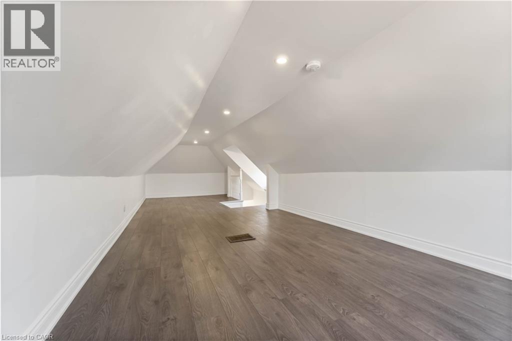 Additional living space featuring dark wood-style floors, vaulted ceiling, and recessed lighting - 934 Barton Street E Unit# 2, Hamilton, ON - Indoor Photo Showing Other Room