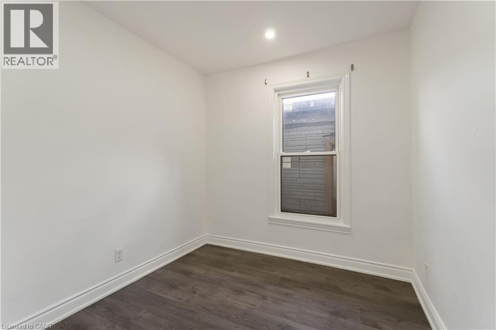Unfurnished room featuring dark wood-style flooring and recessed lighting - 934 Barton Street E Unit# 2, Hamilton, ON - Indoor Photo Showing Other Room