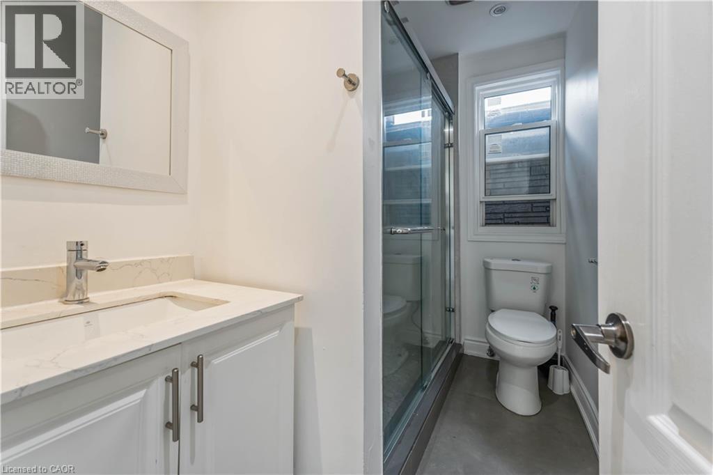 Bathroom featuring vanity, a stall shower, and concrete flooring - 934 Barton Street E Unit# 2, Hamilton, ON - Indoor Photo Showing Bathroom
