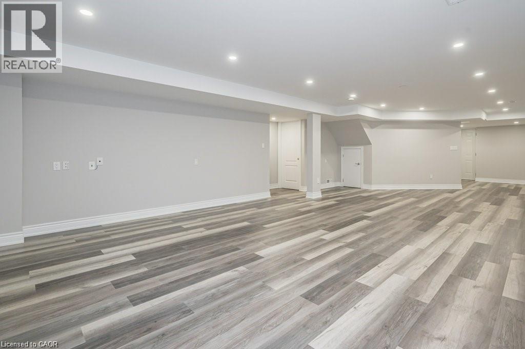 Finished below grade area with recessed lighting and light wood finished floors - 609 Woolgrass Avenue, Waterloo, ON - Indoor Photo Showing Other Room