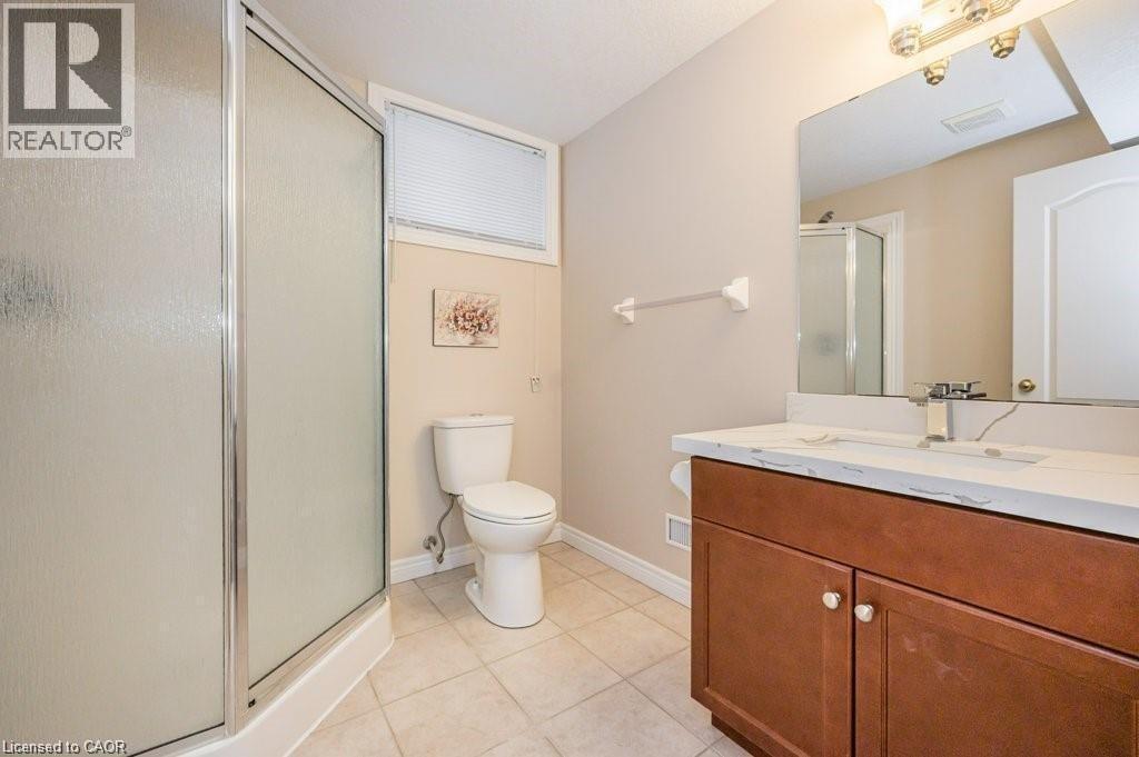 Full bathroom with a shower stall, vanity, and light tile patterned flooring - 609 Woolgrass Avenue, Waterloo, ON - Indoor Photo Showing Bathroom