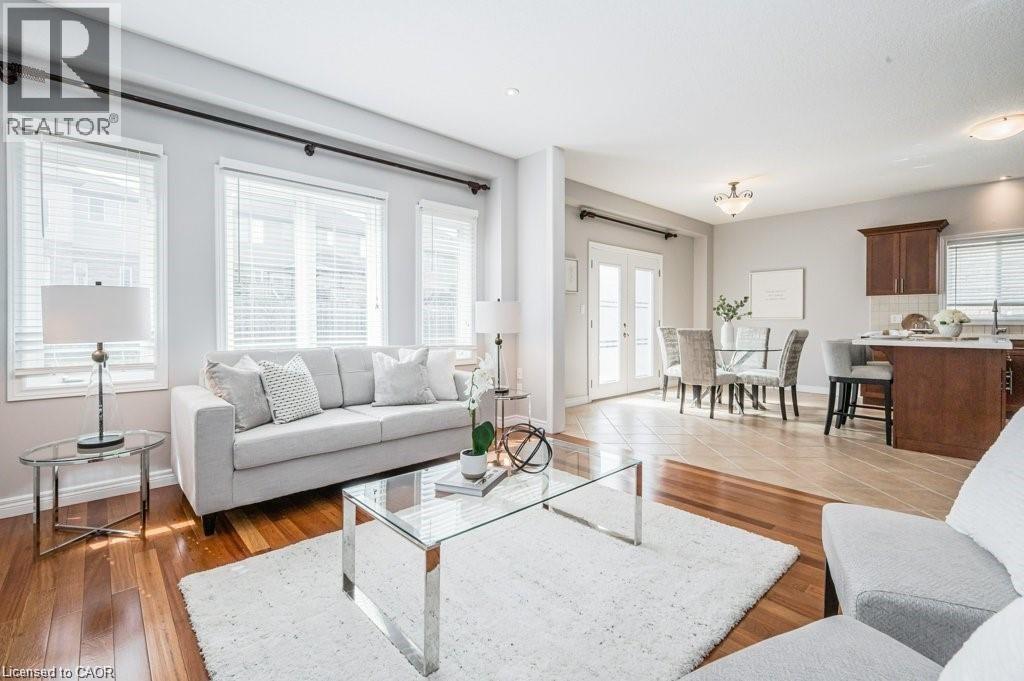 Living area featuring french doors and light wood-style flooring - 609 Woolgrass Avenue, Waterloo, ON - Indoor Photo Showing Living Room