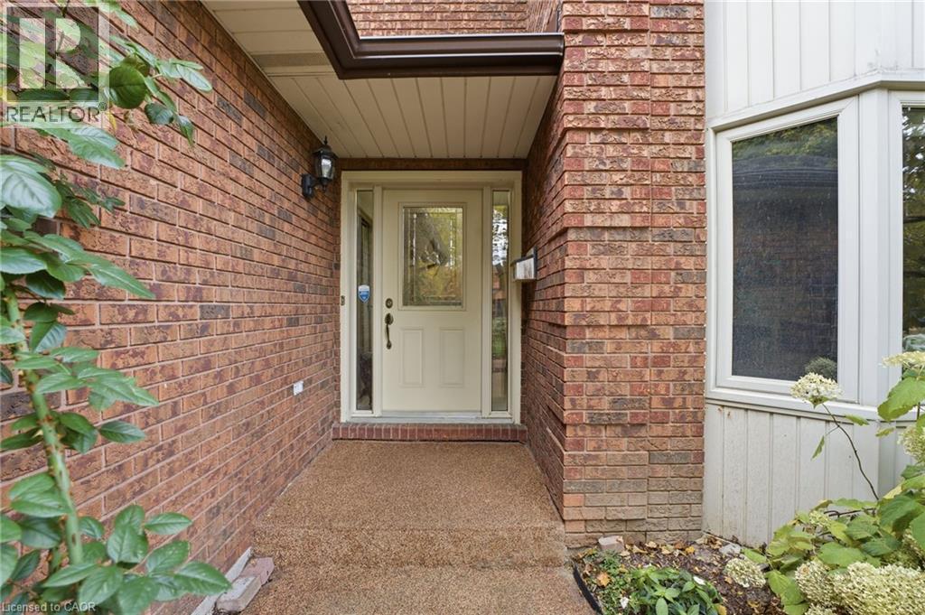 Front door entry with rubbercrete walkway - 668 Tomahawk Crescent, Ancaster, ON - Outdoor With Exterior