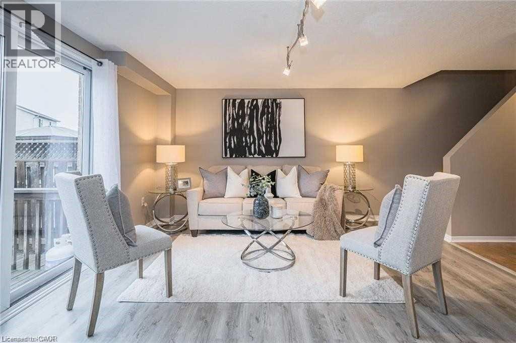 Living room featuring wood finished floors and rail lighting - 27 Max Becker Drive, Kitchener, ON - Indoor Photo Showing Living Room
