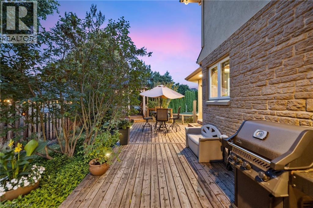 Large deck at dusk with area for grilling and outdoor dining space - 7775 St. Augustine Crescent, Niagara Falls, ON - Outdoor With Deck Patio Veranda