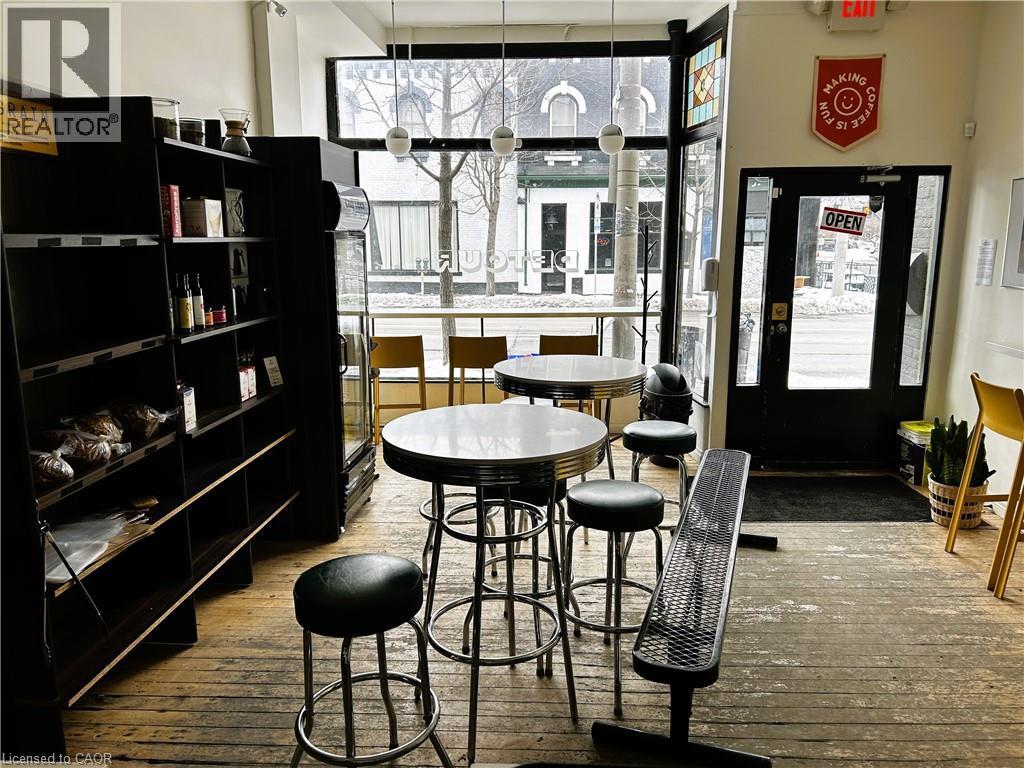 Dining space featuring hardwood / wood-style floors and floor to ceiling windows - 175 John Street S, Hamilton, ON