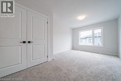 Unfurnished bedroom with carpet floors and a closet -