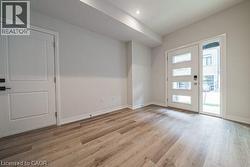Empty room with baseboards and light wood-style floors -