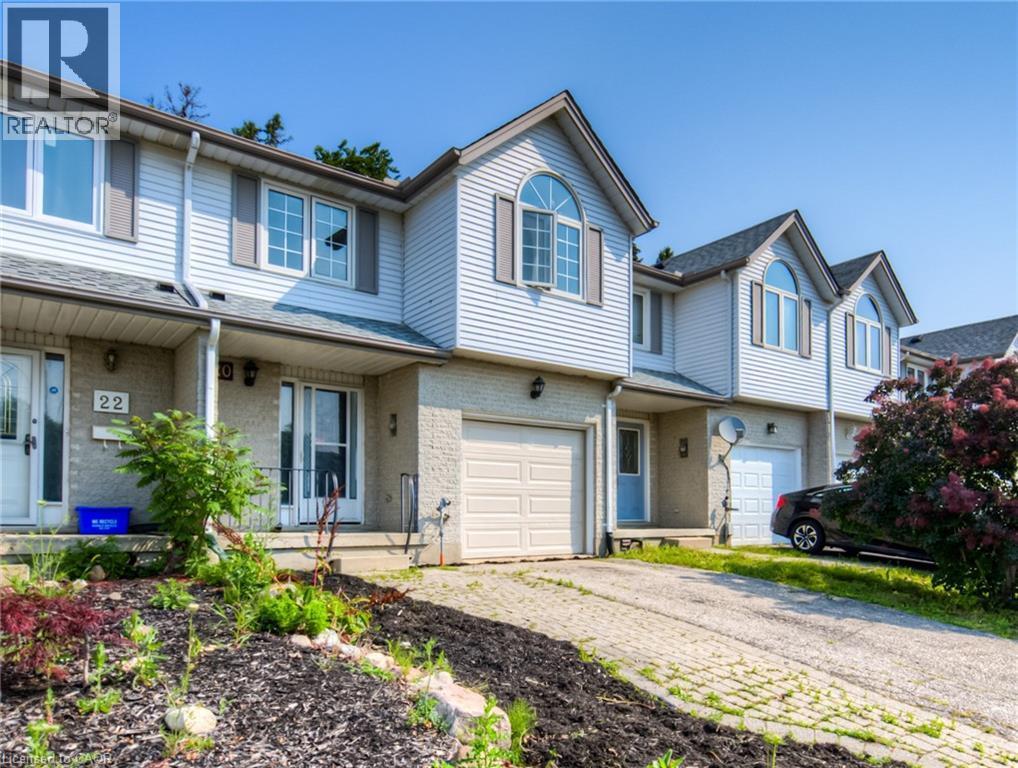 Traditional-style home featuring driveway, a garage, brick siding, and a porch - 20 Bankside Drive, Kitchener, ON - Outdoor With Facade
