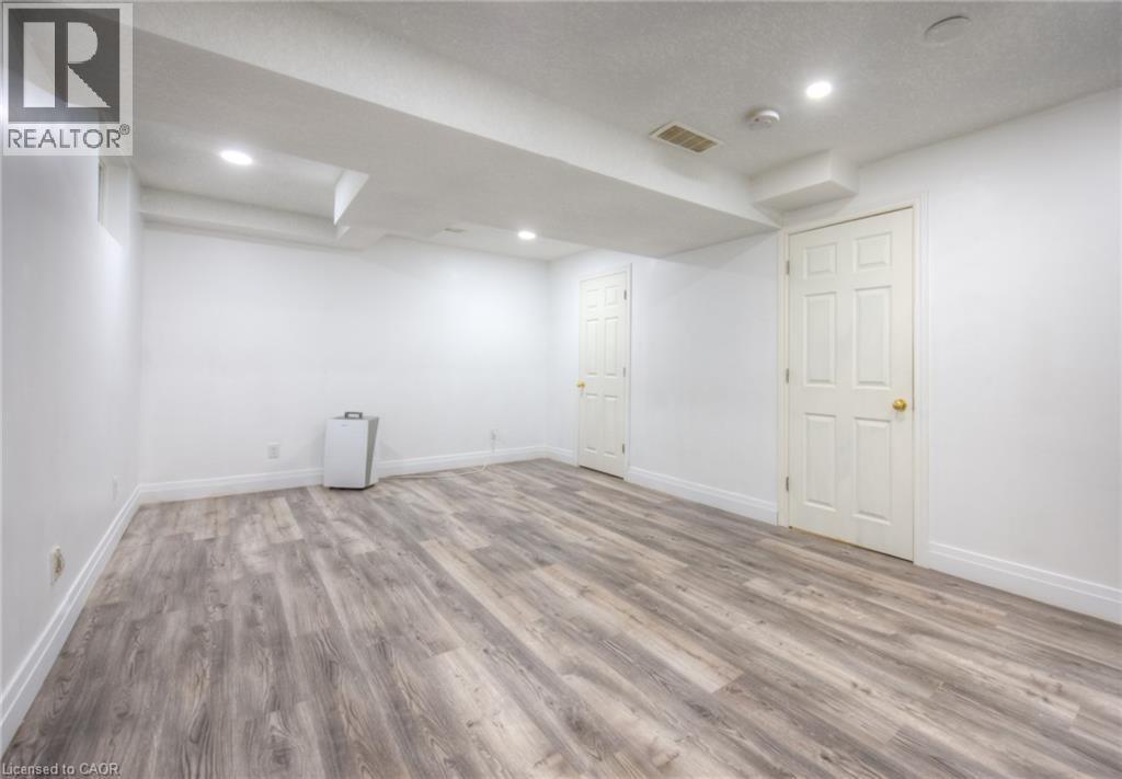 Finished basement featuring light wood-style flooring and recessed lighting - 20 Bankside Drive, Kitchener, ON - Indoor Photo Showing Other Room