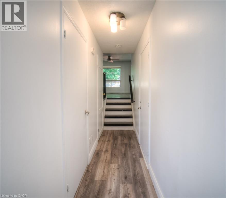 Hallway featuring stairs and dark wood finished floors - 20 Bankside Drive, Kitchener, ON - Indoor Photo Showing Other Room