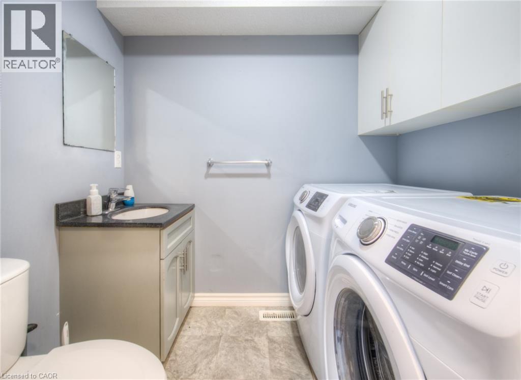 Washroom with independent washer and dryer and light tile patterned floors - 20 Bankside Drive, Kitchener, ON - Indoor Photo Showing Laundry Room