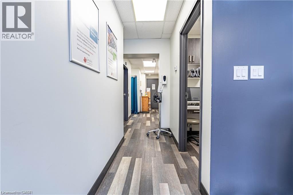 Corridor with a paneled ceiling and dark wood-style floors - 10 Main Street, Mississauga, ON