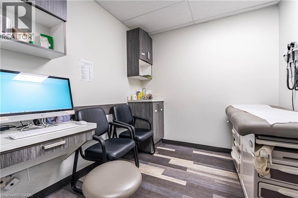 Office featuring a paneled ceiling and dark wood-type flooring - 10 Main Street, Mississauga, ON