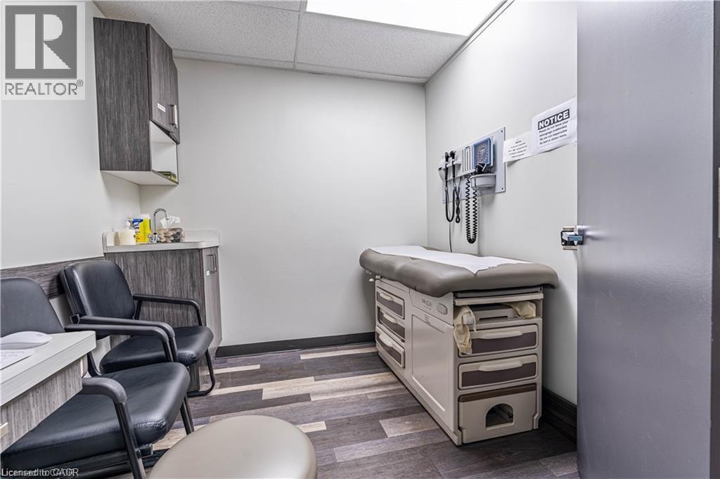 Office space featuring a drop ceiling and dark wood-style floors - 10 Main Street, Mississauga, ON