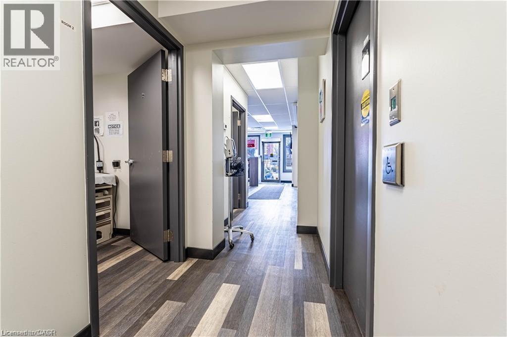 Hallway with dark wood-style floors and baseboards - 10 Main Street, Mississauga, ON