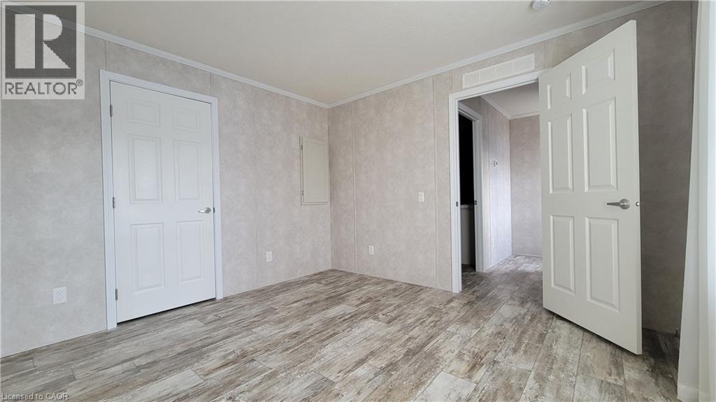 Unfurnished room featuring light wood finished floors and ornamental molding - 24 Macpherson Crescent, Flamborough, ON - Indoor Photo Showing Other Room