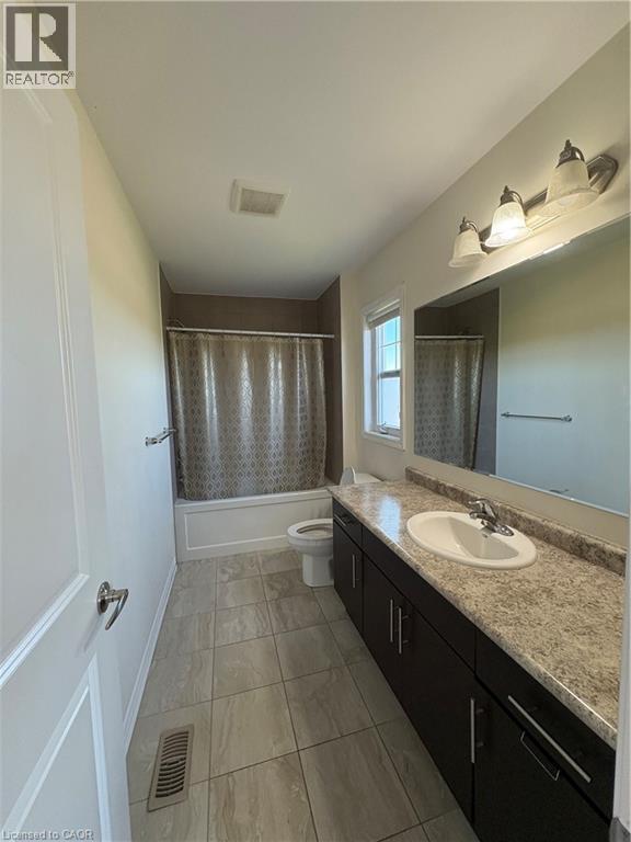 Bathroom with vanity, shower / tub combo with curtain, and light tile patterned flooring - 50 Shoreacres Drive, Kitchener, ON - Indoor Photo Showing Bathroom