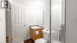 Half bath featuring toilet and vanity -