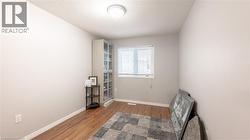 Unfurnished room with a textured ceiling, wood finished floors, and baseboards -