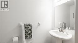 Half bath featuring a sink and toilet -