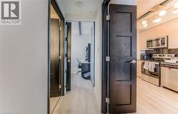 Hall with light hardwood / wood-style flooring -