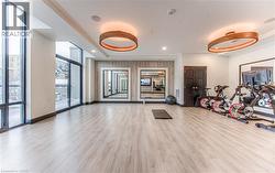 Gym featuring expansive windows and light wood-type flooring -