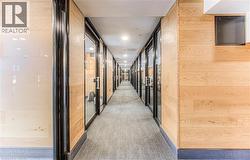 Hallway with wood walls and carpet floors -