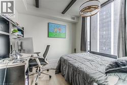 Bedroom featuring hardwood / wood-style flooring and beam ceiling -