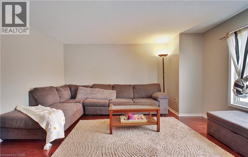 Living room with wood finished floors and a textured ceiling - 206 Westmeadow Drive, Kitchener, ON - Indoor Photo Showing Living Room