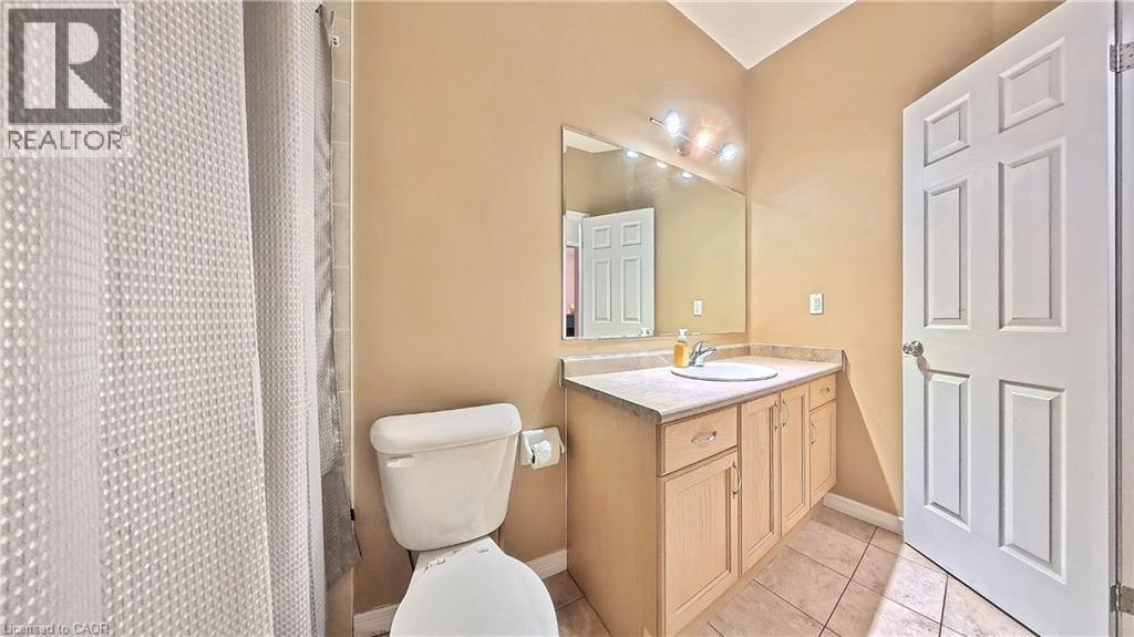 Full bath with vanity, a shower with shower curtain, and light tile patterned flooring - 206 Westmeadow Drive, Kitchener, ON - Indoor Photo Showing Bathroom