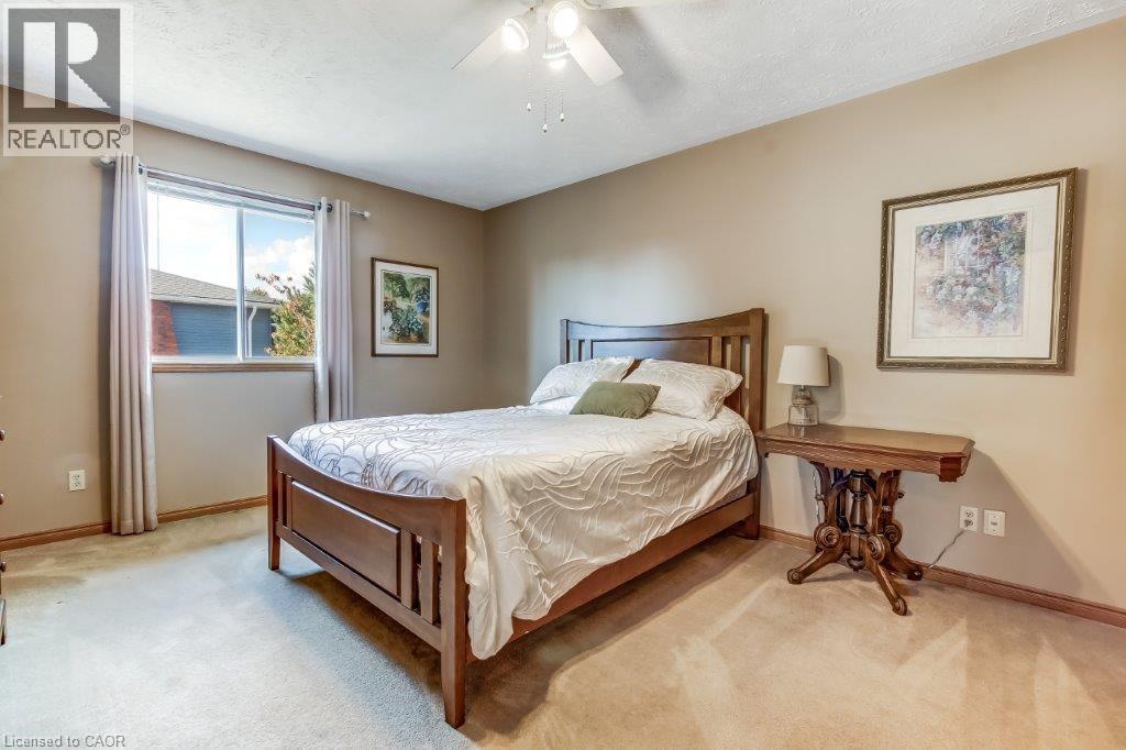 Carpeted bedroom featuring a ceiling fan and a textured ceiling - 2 Falls Crescent, Simcoe, ON - Indoor Photo Showing Bedroom