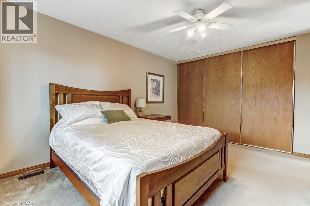 Bedroom with a closet, light colored carpet, and ceiling fan - 2 Falls Crescent, Simcoe, ON - Indoor Photo Showing Bedroom