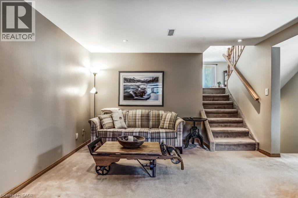 Living room featuring light carpet and stairway - 2 Falls Crescent, Simcoe, ON - Indoor