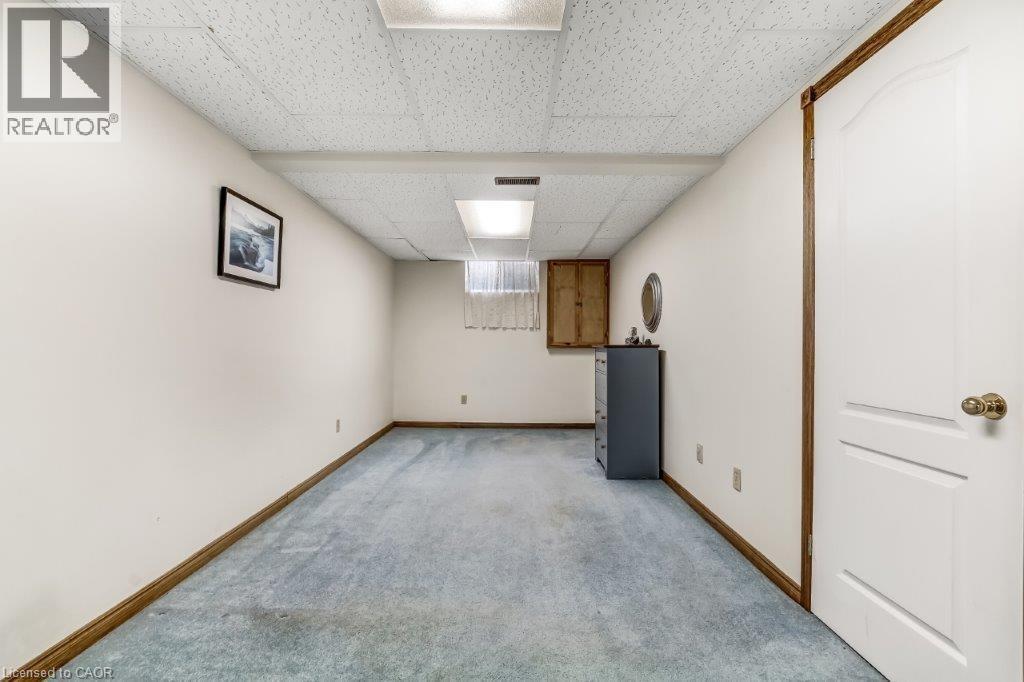 Below grade area with a drop ceiling and carpet floors - 2 Falls Crescent, Simcoe, ON - Indoor