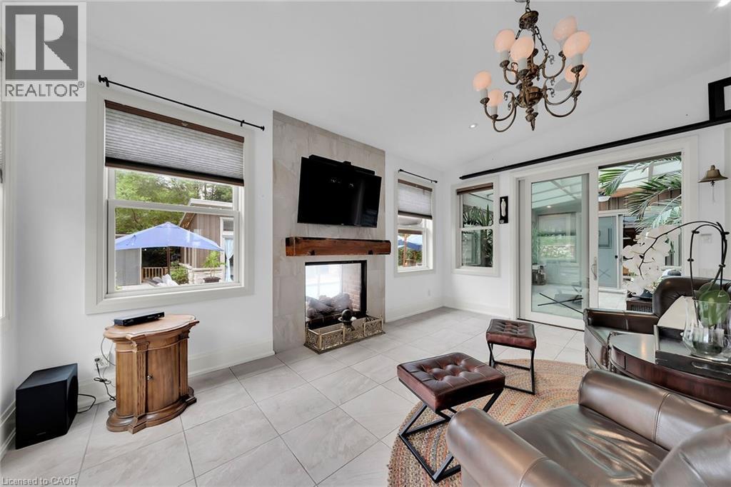 Living area with tile patterned floors, plenty of natural light, and a chandelier - 404 Mountain Brow Boulevard E, Hamilton, ON - Indoor Photo Showing Other Room With Fireplace