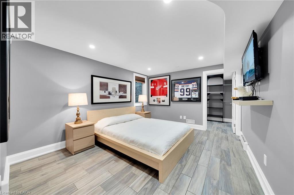 Bedroom with a spacious closet, light wood-style floors, and recessed lighting - 404 Mountain Brow Boulevard E, Hamilton, ON - Indoor Photo Showing Bedroom