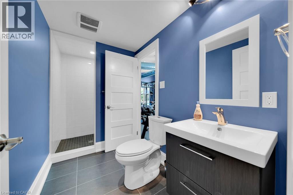 Full bath featuring dark tile patterned flooring, vanity, and a shower stall - 404 Mountain Brow Boulevard E, Hamilton, ON - Indoor Photo Showing Bathroom