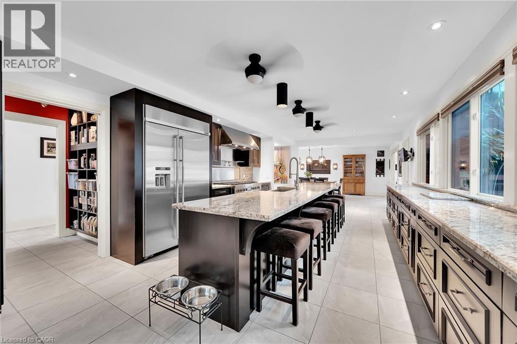 Kitchen featuring a breakfast bar, built in fridge, light stone countertops, recessed lighting, and a large island - 404 Mountain Brow Boulevard E, Hamilton, ON - Indoor Photo Showing Kitchen With Upgraded Kitchen