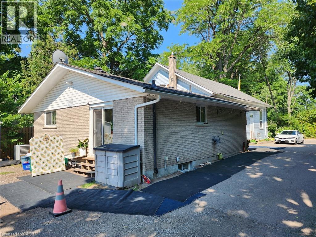 View of side of home featuring brick siding and a chimney - 67 Old Mill Road, Cambridge, ON